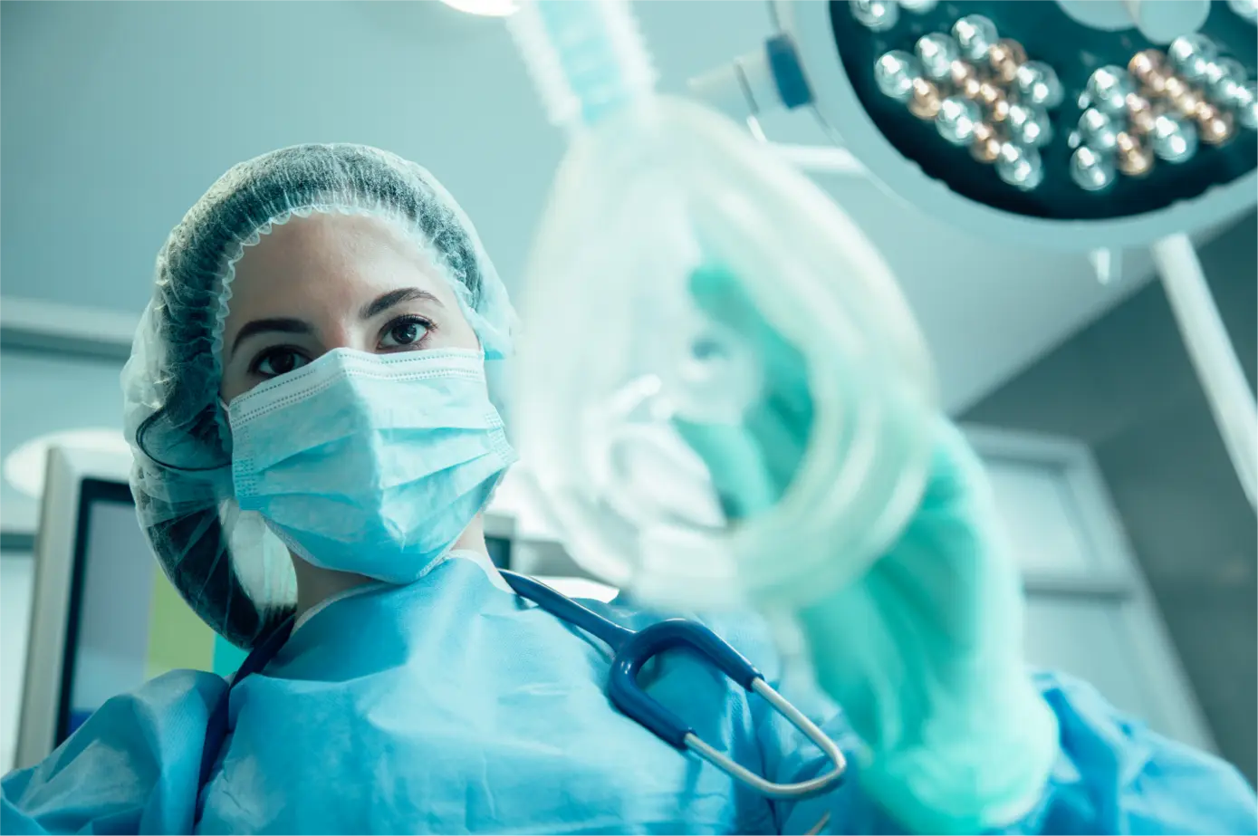 Female surgeon putting a mask on her patient